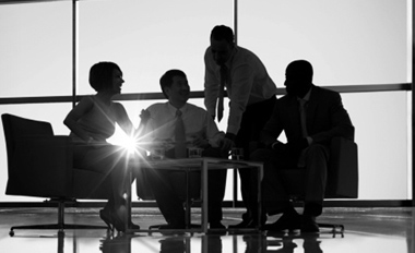 Executives meeting around a table in a bright office
